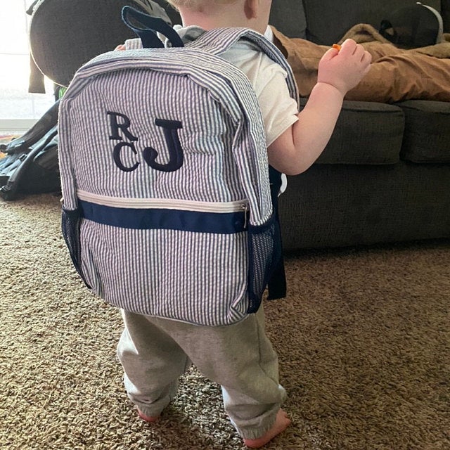 navy blue seersucker backpack with embroidered monogram