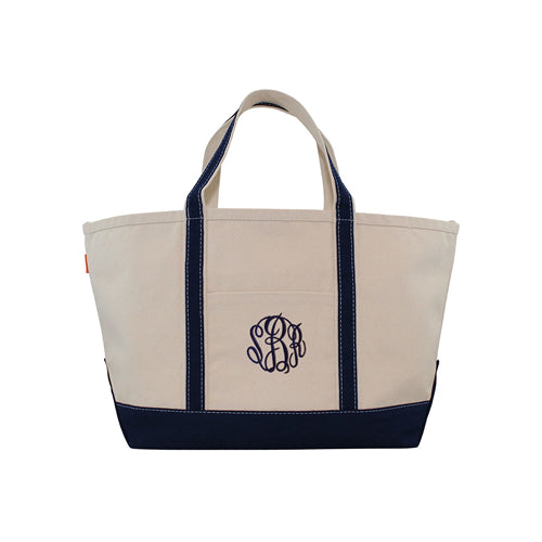 Beige tote bag with navy accents and a monogram on a white background