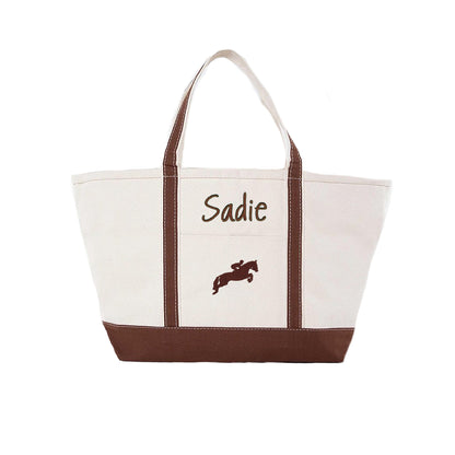 Canvas tote bag with brown accents and embroidered horse and rider design on a white background
