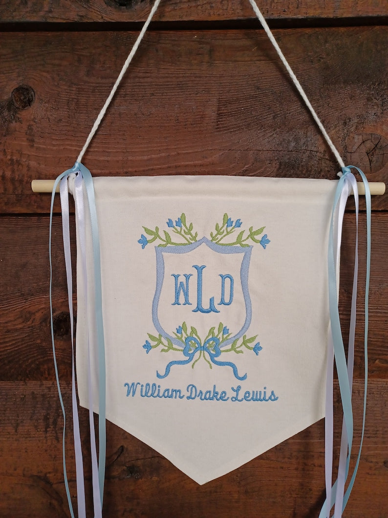 Blue floral crest banner with monogram