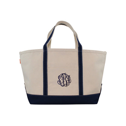 Beige tote bag with navy accents and a monogram on a white background