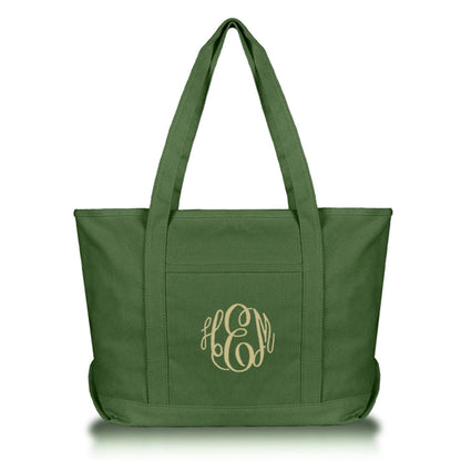 Green tote bag with an embroidered monogram on a white background