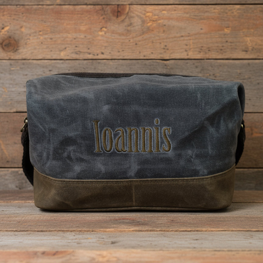 slate bag with 'Ioannis' embroidery on a wooden background