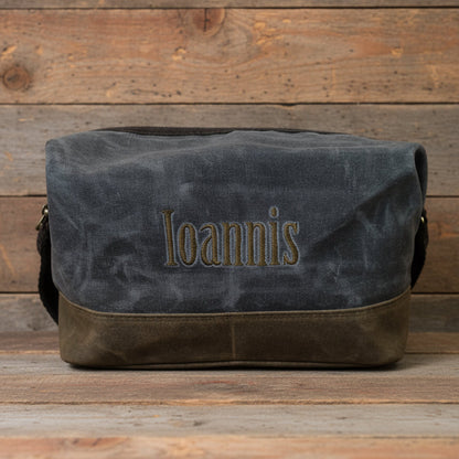 slate bag with 'Ioannis' embroidery on a wooden background